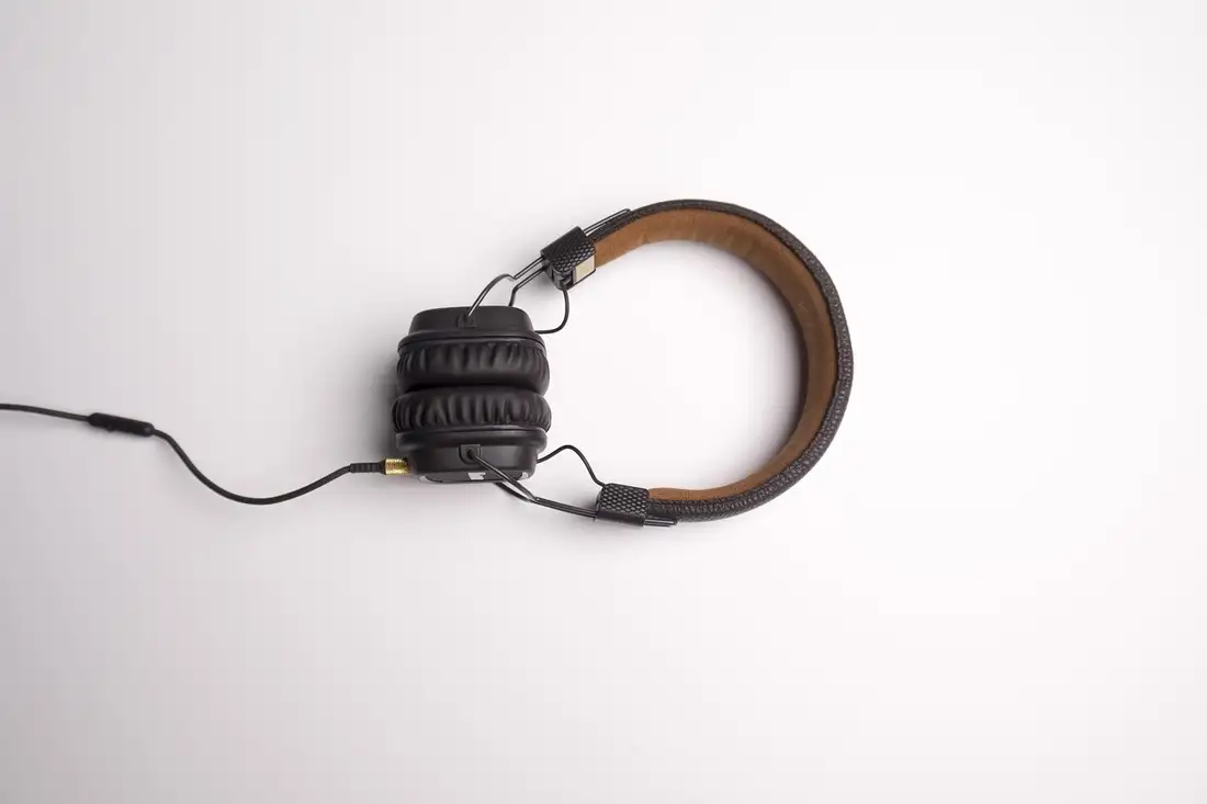 Leather over-ear headphones lying flat, used for Thai audio lessons and ThaiPod101 alternatives